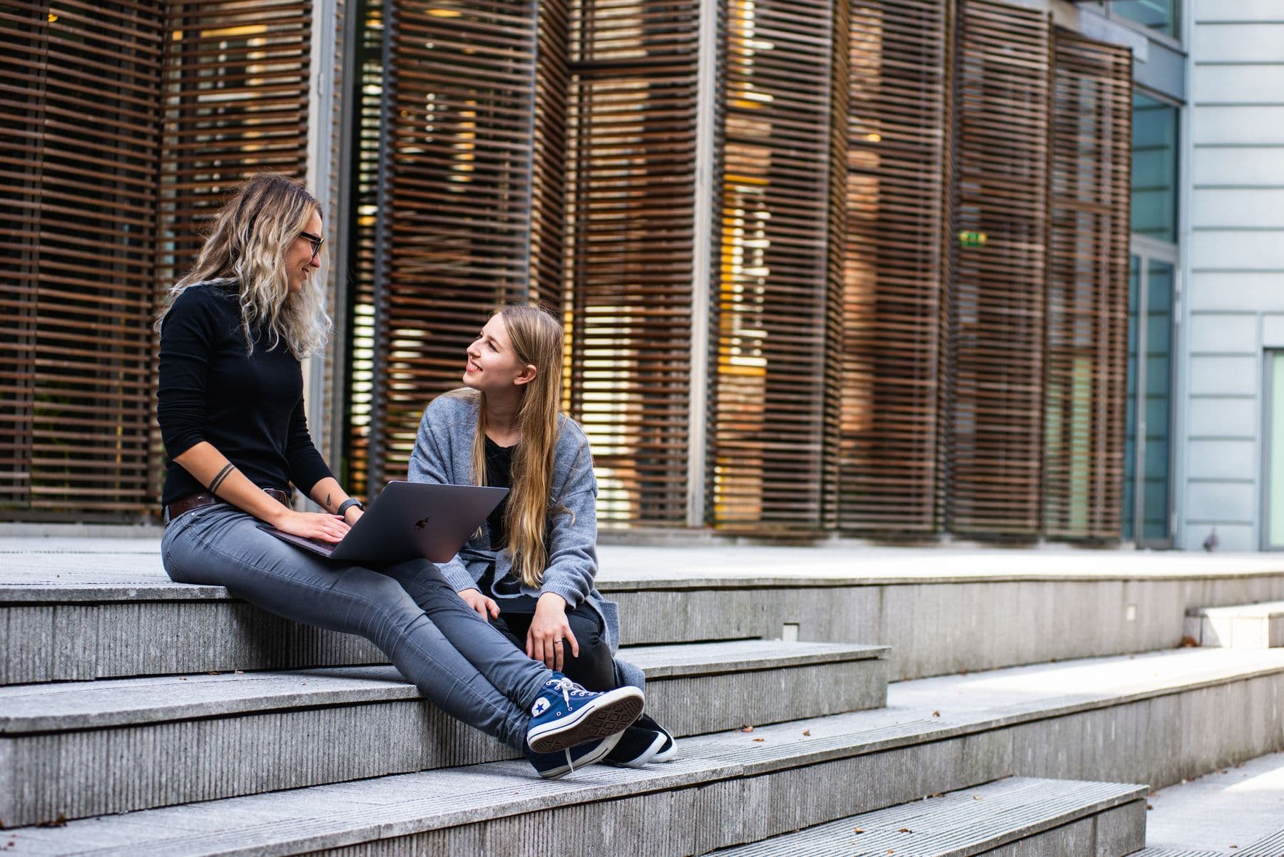 A university mentor and student reviewing work together on campus